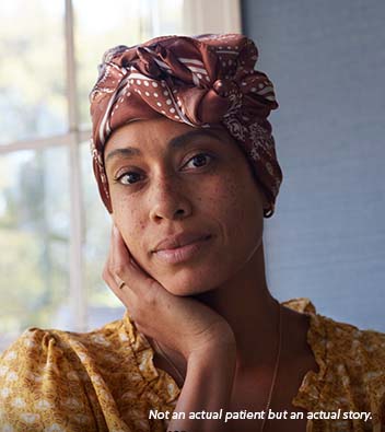 A Black woman in her early 40s wearing a paisley headscarf and a yellow shirt, with a calm expression and her hand against her cheek. Not an actual patient, but an actual story.