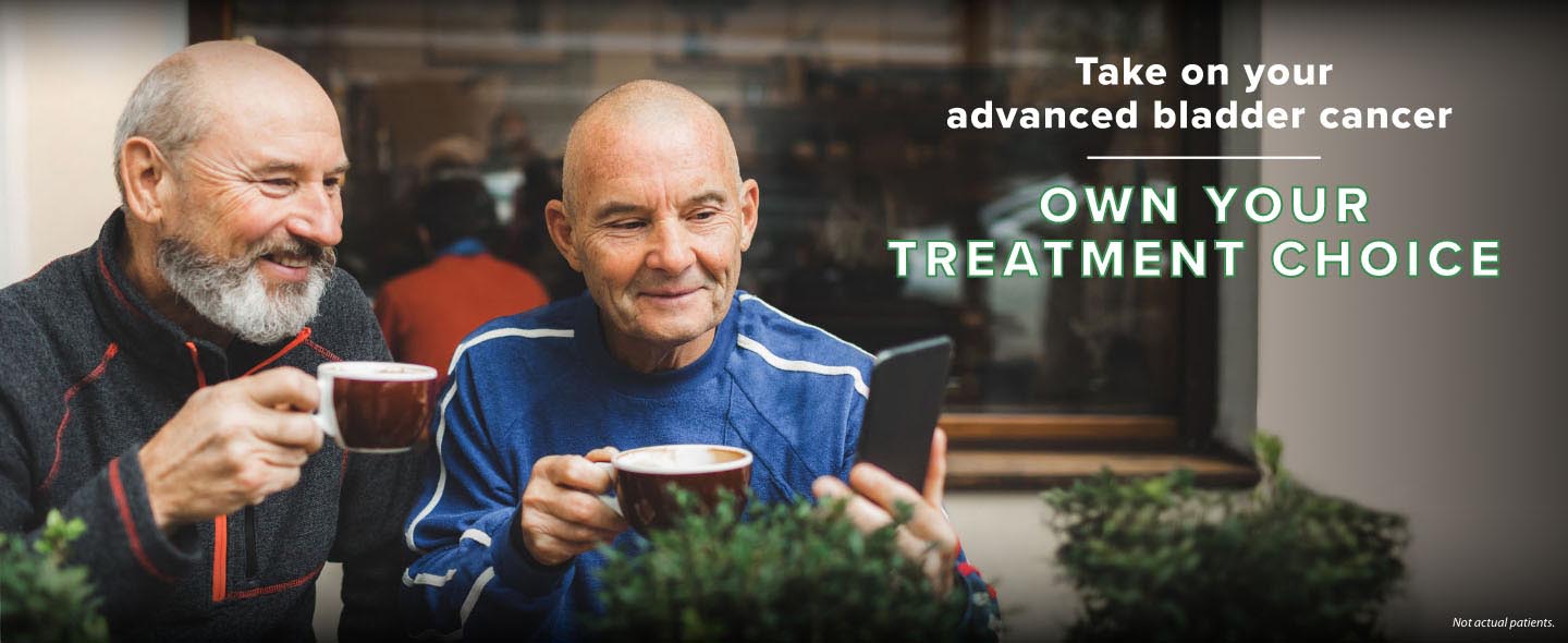 Take on your advanced bladder cancer. Own your treatment choice. Two white men in their 70s are sitting at a coffeeshop. One man is holding a phone, and they are looking at it, softly smiling.